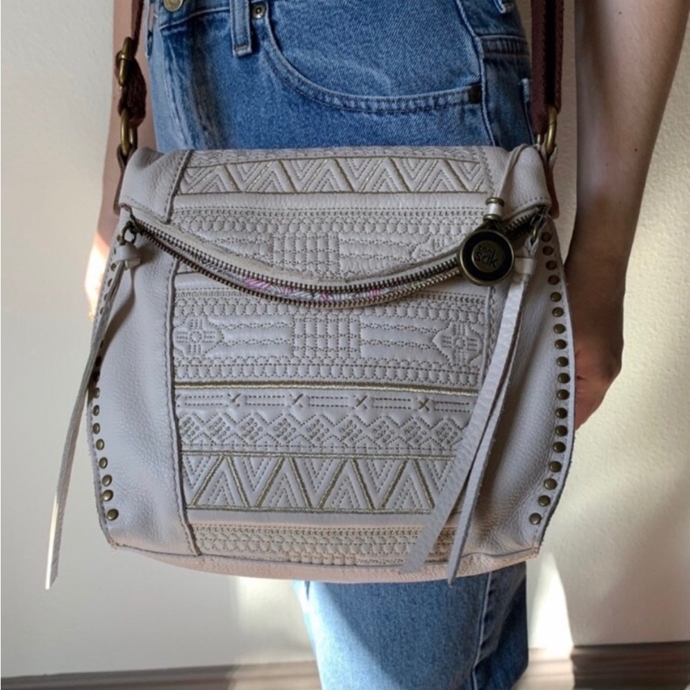 The Sak Cream Crossbody Bag with Textured Material and Adjustable Strap